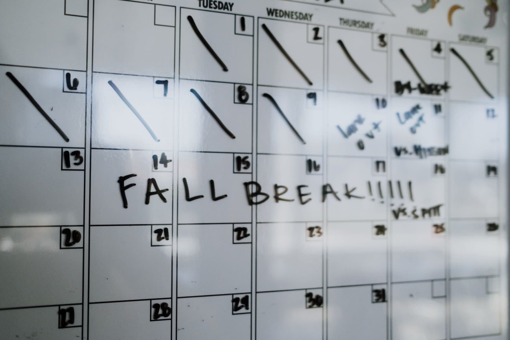 A wall calendar with school days crossed off and “Fall break” written across a week